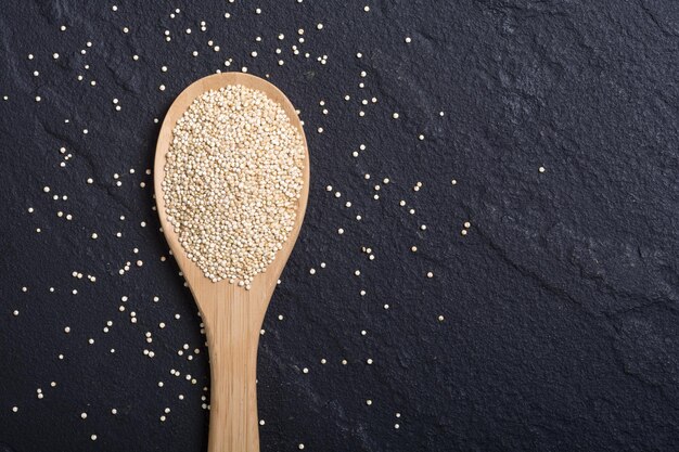 Quinoa bianca e rossa nera in cucchiaio su sfondo di legno Superfood