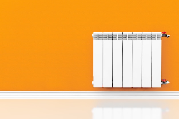 Radiatore di riscaldamento moderno con parete arancione su sfondo bianco