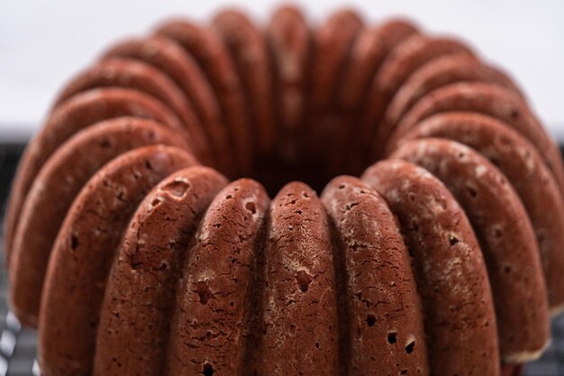 Raffreddamento di ciambellone di velluto rosso appena sfornato su uno stendibiancheria da cucina.