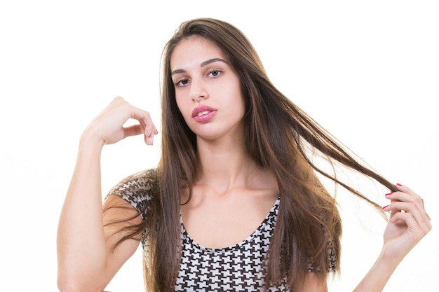 Ragazza abbastanza giovane dell'adolescente con le mani nei capelli