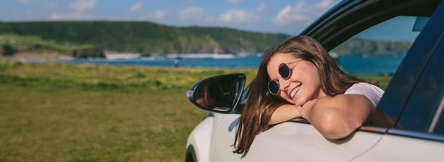 Ragazza appoggiata al finestrino dell'auto