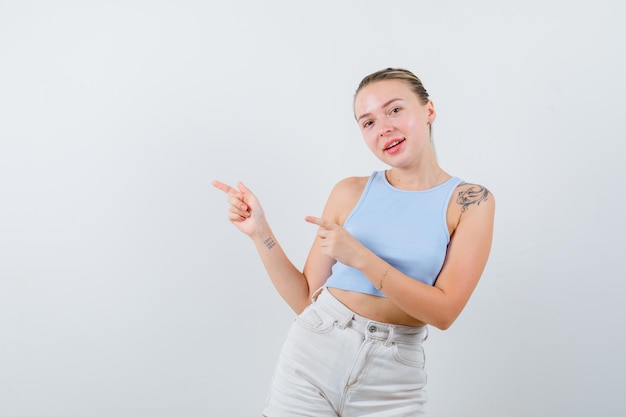 ragazza bionda sta mostrando il lato sinistro su sfondo bianco