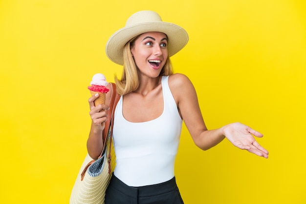 Ragazza bionda uruguaiana in estate con gelato isolato su sfondo giallo con espressione a sorpresa mentre guarda di lato