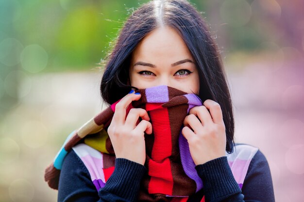 Ragazza Brunet con sciarpa colorata nel parco