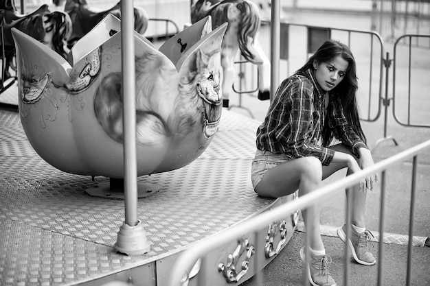 Ragazza carina con un trucco da clown su una foto in bianco e nero di sfondo