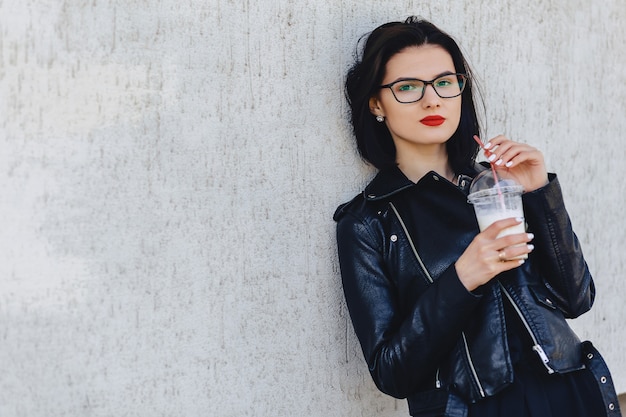 Ragazza carina con una bevanda fredda in giornata di sole