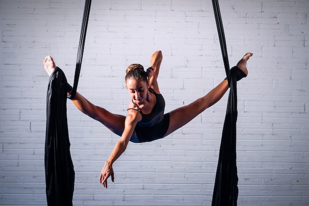 Ragazza che fa acrobazie aeree su sete