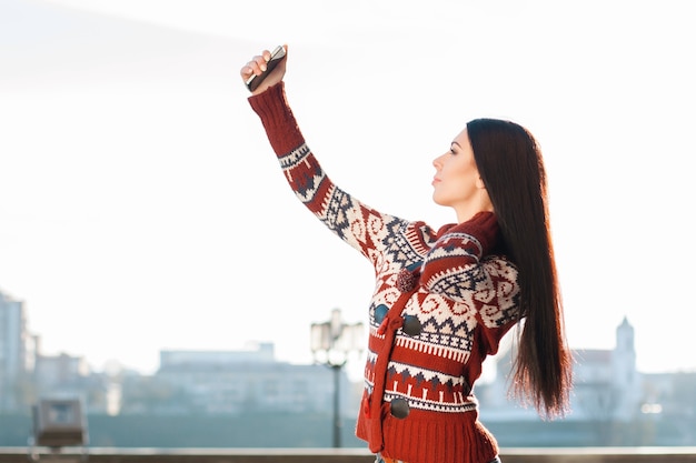 Ragazza che fa Selfie sul telefono in città.