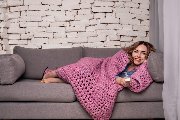 Ragazza che guarda la tv, ragazza sdraiata sul divano, ragazza che riposa