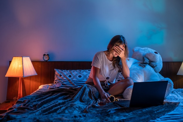 Ragazza che guarda un film horror sul suo computer portatile