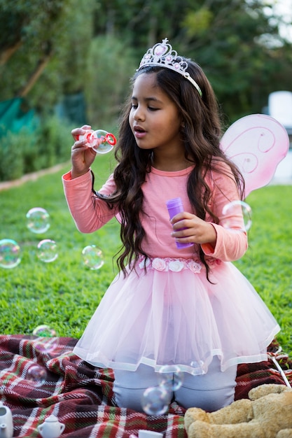 Ragazza che soffia bolle di sapone