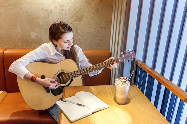 Ragazza che suona la chitarra al bar