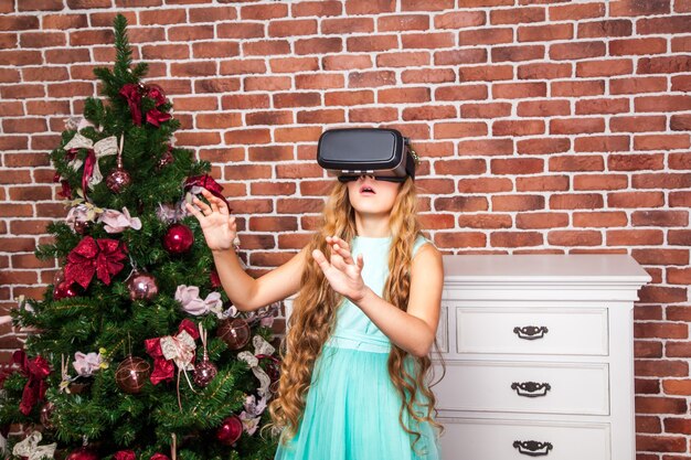 Ragazza che utilizza le cuffie per realtà virtuale durante le vacanze di capodanno