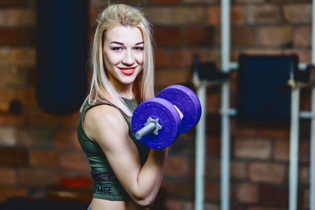 Ragazza con manubri in palestra