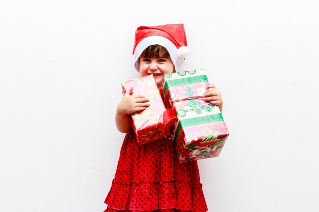 Ragazza con regali e cappello di natale, sfondo bianco