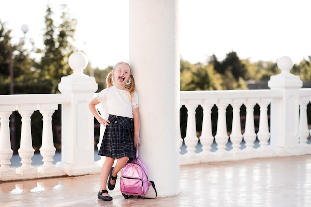 Ragazza del bambino dell'allievo che posa all'aperto