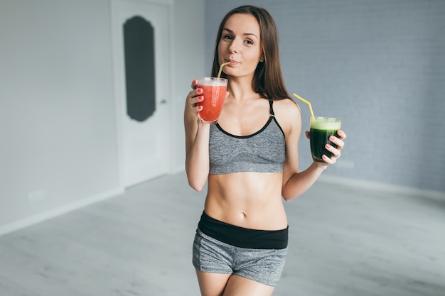 Ragazza di forma fisica che beve succo di frutta