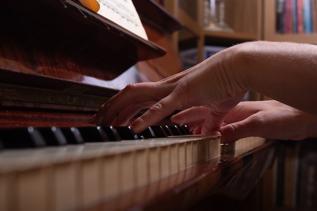 Ragazza e pianoforte a casa messa a fuoco selettiva