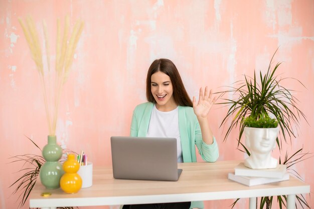 Ragazza felice al lavoro di ufficio a casa di videochiamata online da casa