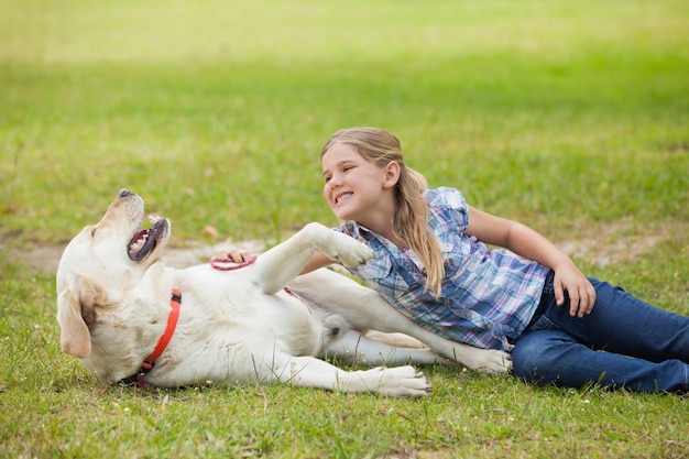 Ragazza felice che gioca con il cane al parco