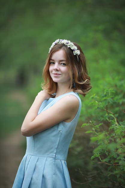 Ragazza in abito blu nel parco verde