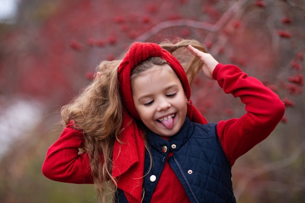 ragazza in abito rosso nella foresta di autunno