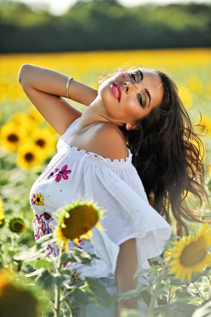 Ragazza in camicia all'aperto in mezzo al girasole