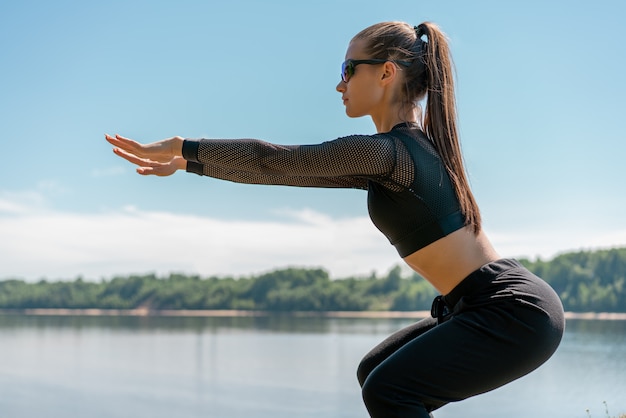 Ragazza in uniforme e occhiali da sole che fanno sport in un parco