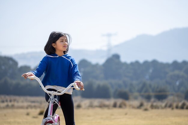 Ragazza messicana in bicicletta all'aperto