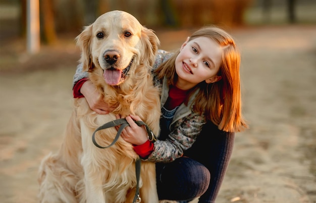 Ragazza preadolescente con cane golden retriever