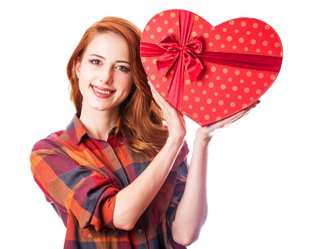 Ragazza rossa con regalo. Foto su sfondo bianco