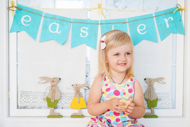 Ragazza sveglia del bambino con la decorazione di pasqua