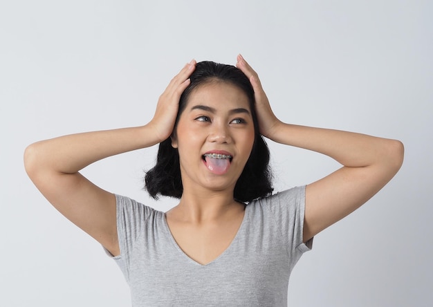 Ragazza teenager dell'apparecchio dentale che sorride alla ricerca su una macchina fotografica