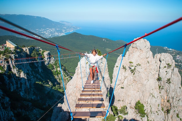 Ragazze che attraversano il baratro sul ponte di corda