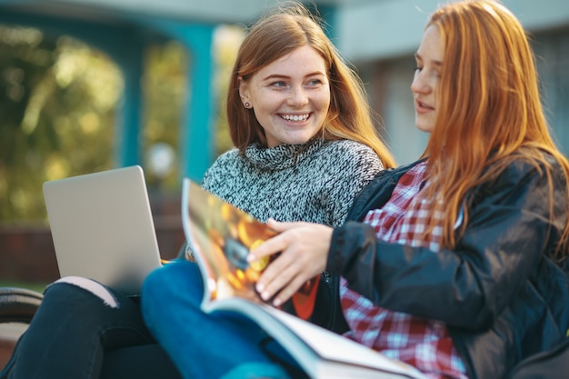 Ragazze degli studenti universitari che discutono e che si divertono