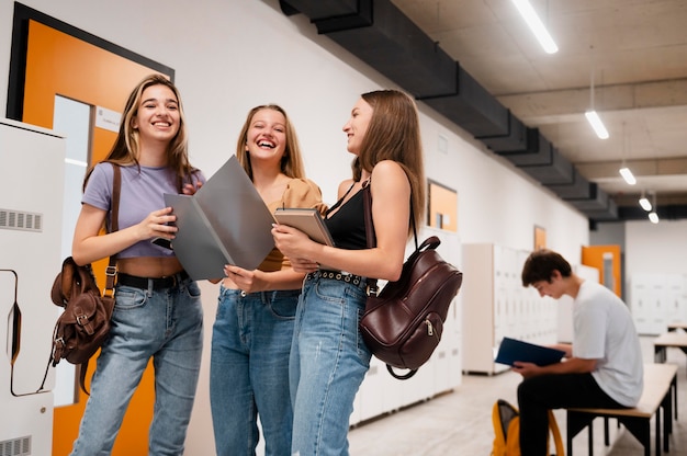 Ragazze sorridenti di tiro medio a scuola