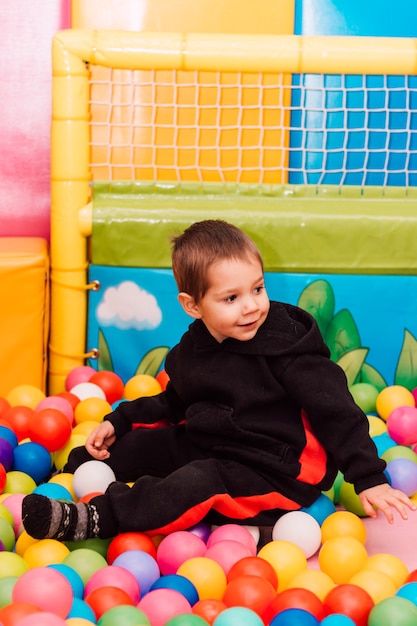 Ragazzino che gioca allegramente nella stanza dei giochi per bambini