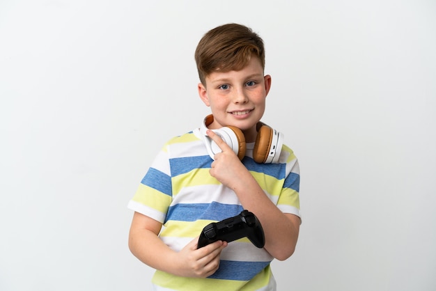 Ragazzino dai capelli rossi che tiene in mano un game pad isolato su sfondo bianco rivolto verso il lato per presentare un prodotto