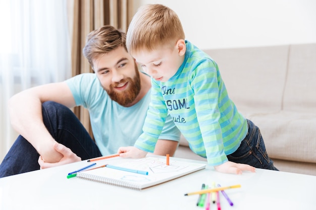 Ragazzino felice e suo padre che si riuniscono a casa