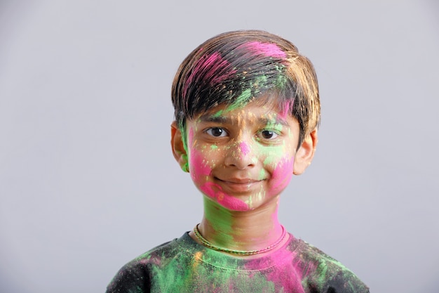 Ragazzino indiano che gioca con il colore nel festival di holi