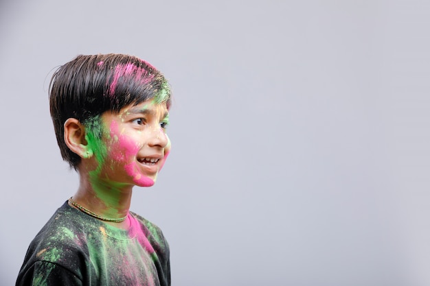 Ragazzino indiano che gioca con il colore nel festival di holi