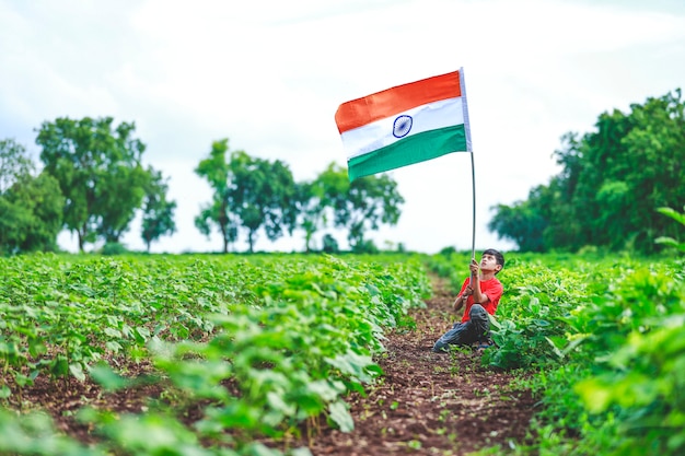 Ragazzino sveglio con la bandiera tricolore nazionale indiana