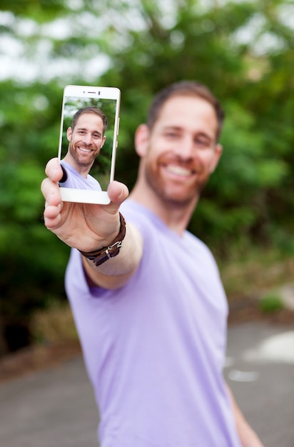 Ragazzo casuale in un parco di scattare una foto