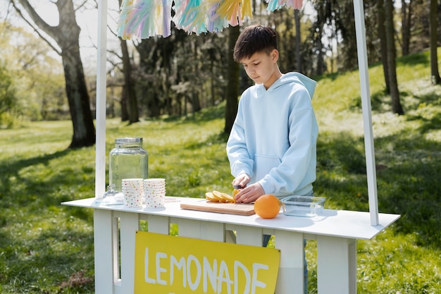 Ragazzo che fa vista laterale della limonata