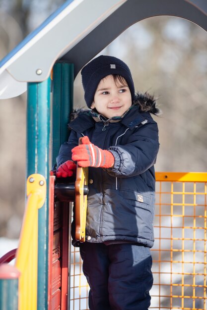 Ragazzo che gioca nel parco invernale