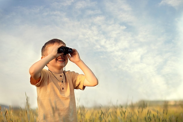 ragazzo che tiene il binocolo nelle sue mani e guarda