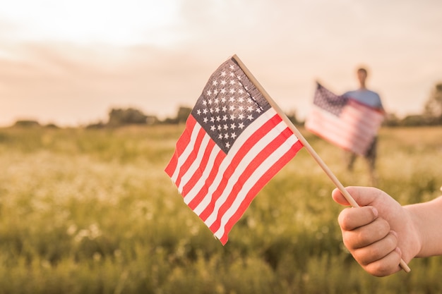 Ragazzo che tiene in mano una bandiera americana