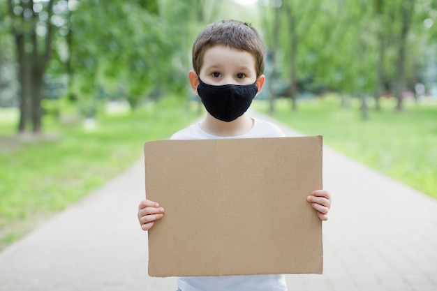 Ragazzo con il segno di cartone vuoto