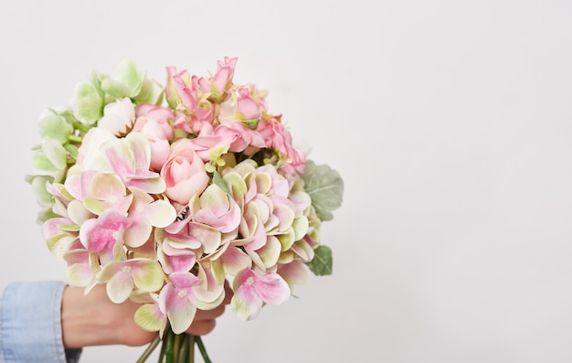 Ragazzo del bambino con il mazzo del fondo dei fiori. Festa della mamma.