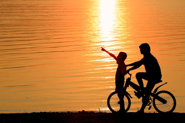 Ragazzo e ragazza sulla priorità bassa della siluetta di BMX.